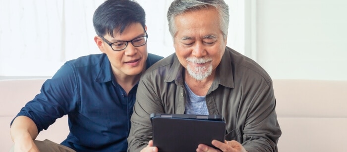 Two men using a tablet with automated cyberattack defense