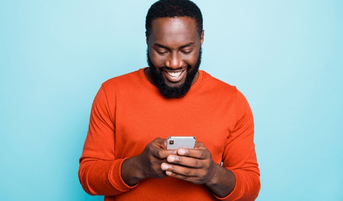 Man happily holding phone