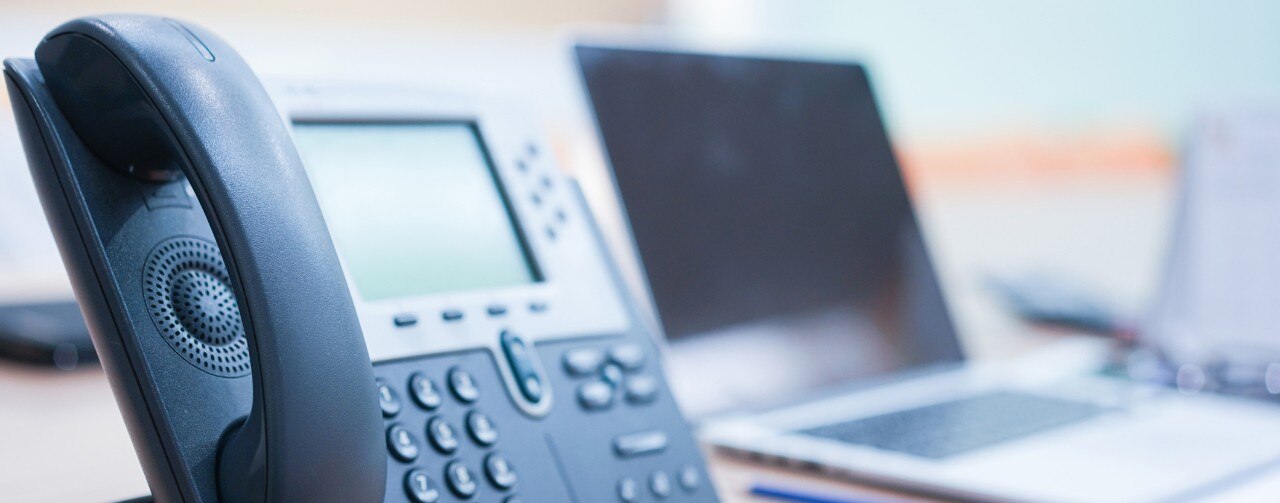 915623194 close up soft focus on telephone device at office desk